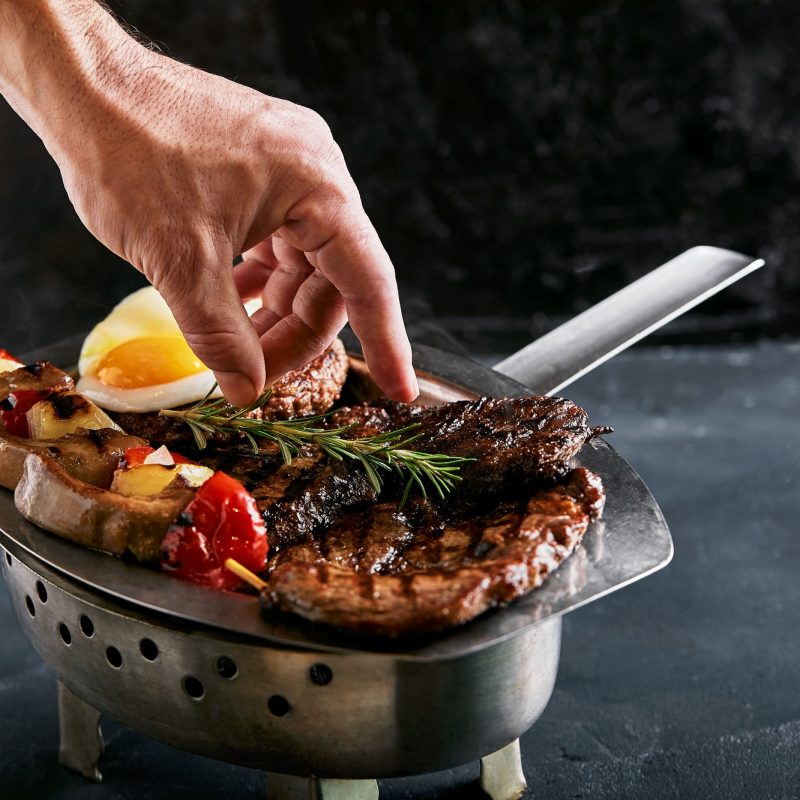 Grilled meat platter. Assorted delicious grilled meat with vegetables. Grilled mixed meat with